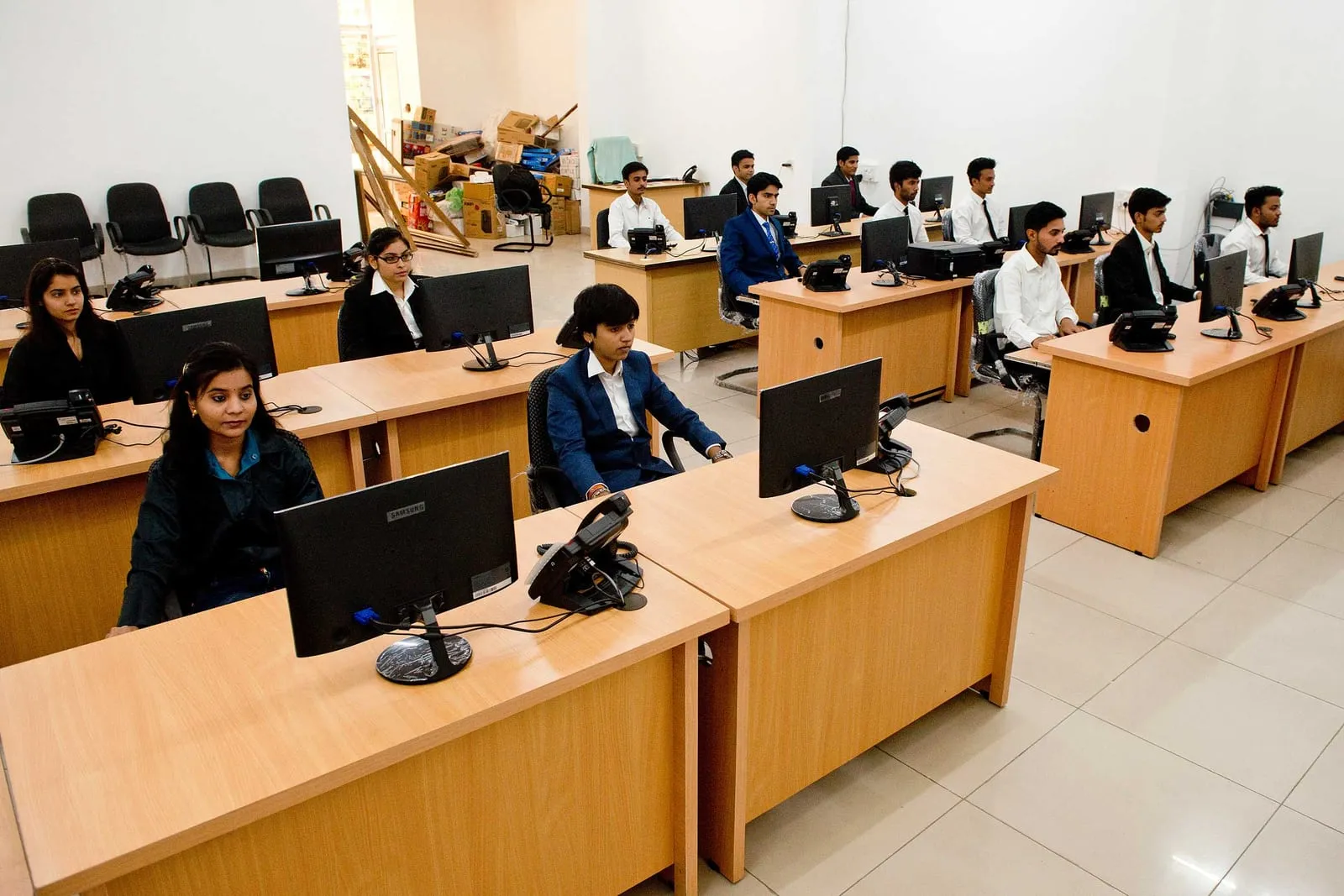 SiOnline staff seated at computers on the support floor